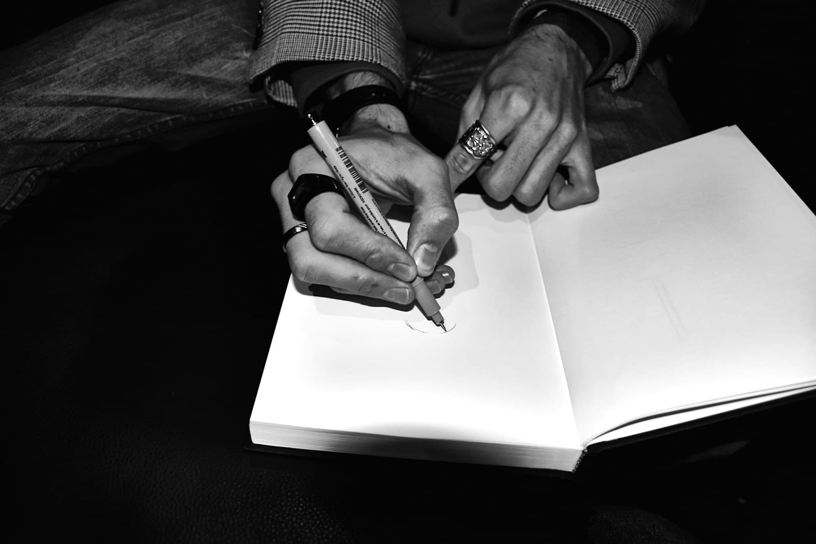 Hands writing in a notebook